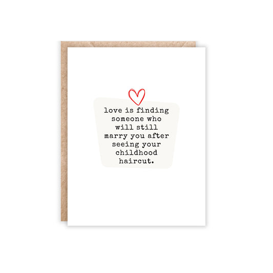 Greeting card with heart in the middle and underneath text 'Love is finding someone who will still marry you after seeing your childhood haircut.