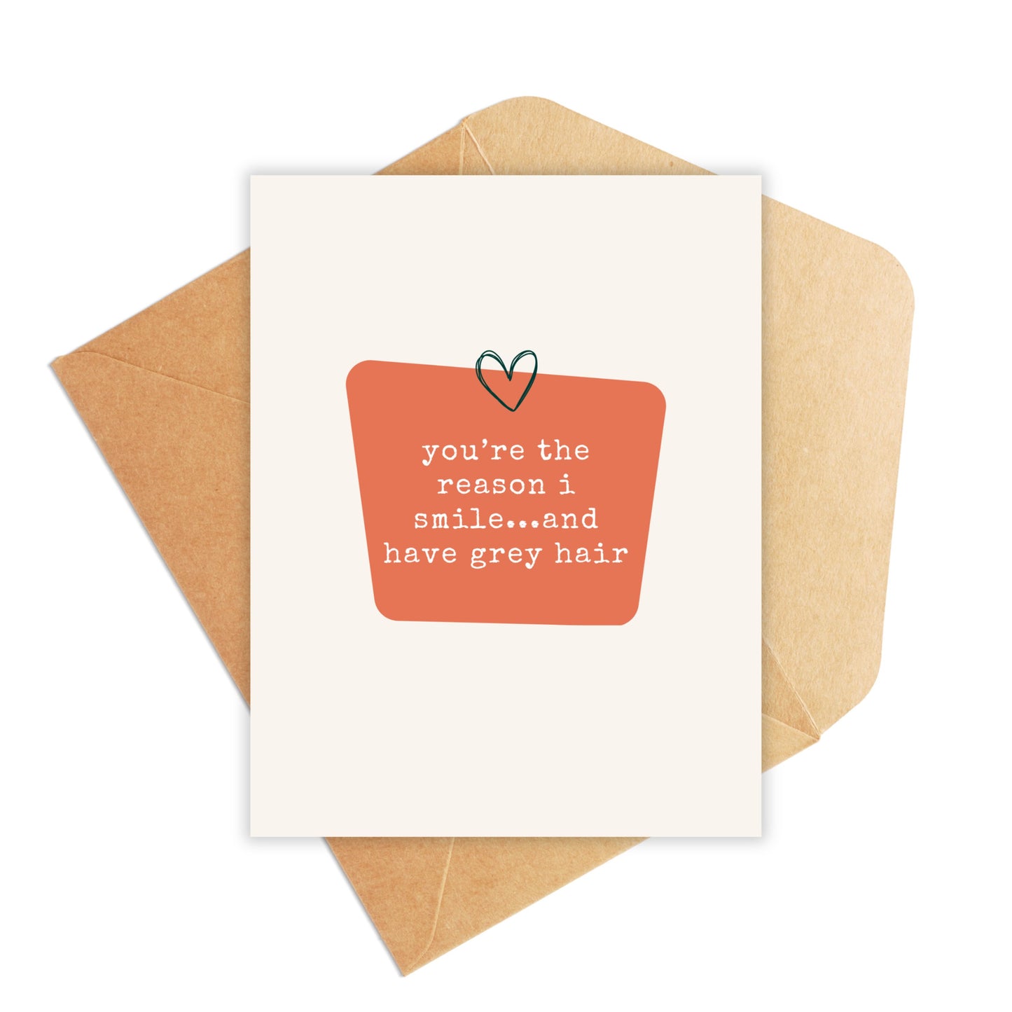 mockup with kraft envelope and card that says you're the reason i smile...and have grey hair