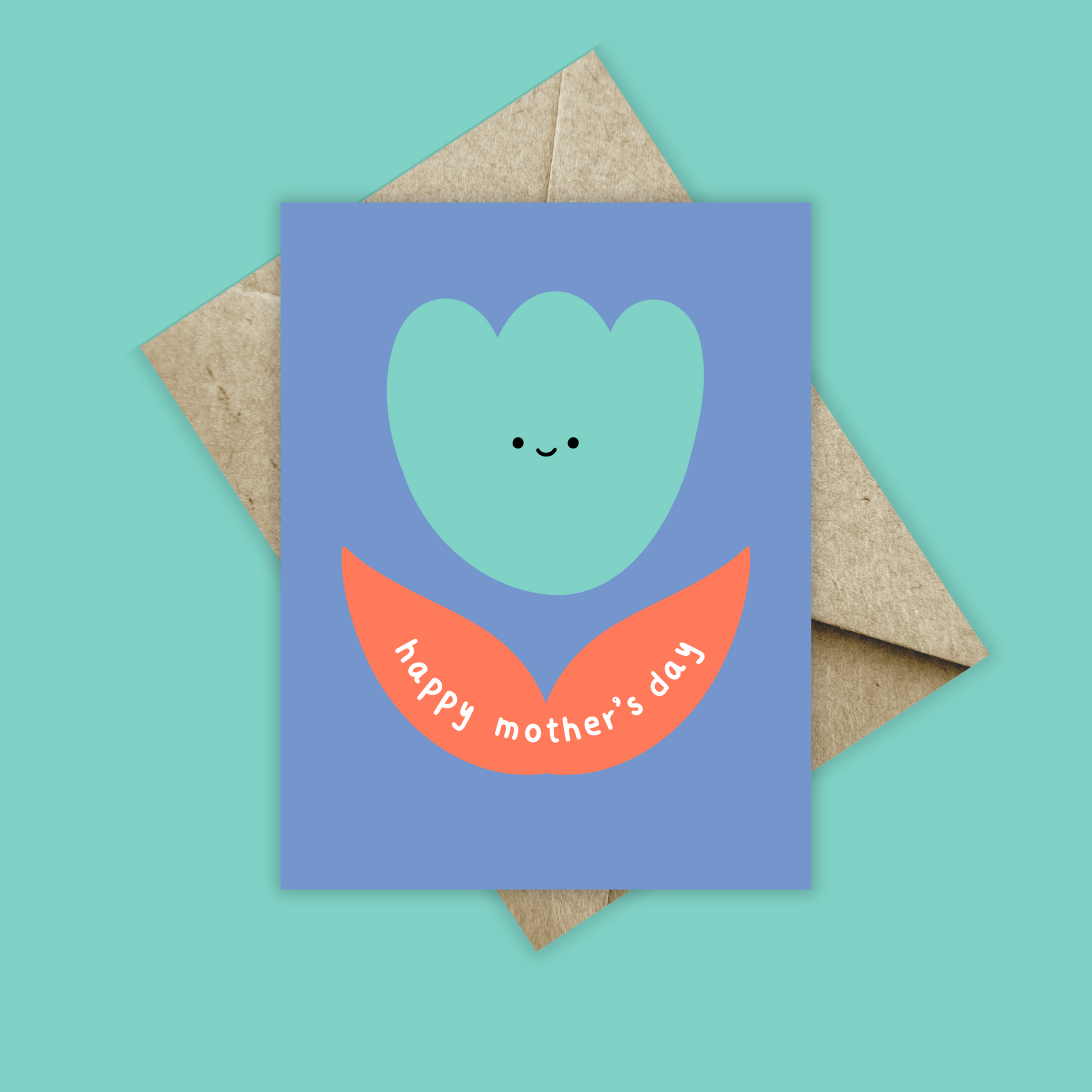 Greeting card with blue background and an orange and teal abstract tulip. Has a tiny smiley face and happy mother's day written in the leaves. Shown with a brown kraft envelope