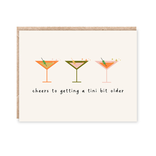 greeting card with 3 martini glasses in the middle and underneath reads 'cheers to getting a tini bit older'