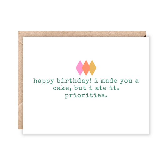 white landscape size card with the text 'happy birthday, i made you a cake, but i ate it. priorities.