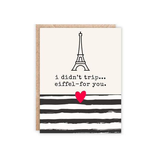 card with a black and white striped bottom and an eiffel tower in the middle with the text i didn't trip...eiffel for you.