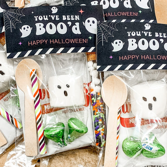 you've been boo'd halloween hot cocoa favor. contains hot cocoa, ghost marshmallow, sprinkles, mini marshmallows, hershey kisses, straw and wooden stirring spoon